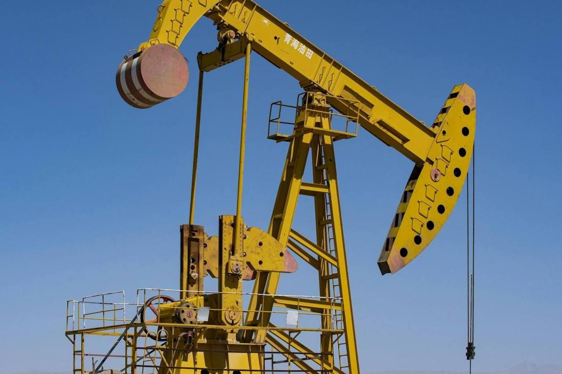 An oil pumpjack against a blue sky