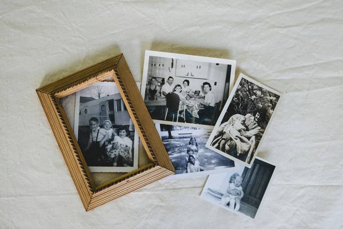 Old family photographs spread out on a table